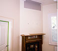A corner fireplace in a small room