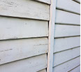 A large gap between the old house and the new weatherboards