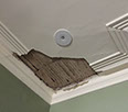 Old lath and plaster ceiling has fallen away from water damage
